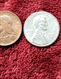 1985 no mint mark  1 Penny shiny silver color completely  MS64